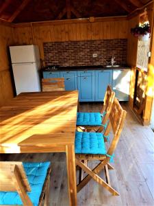 a wooden table and chairs in a kitchen at Casa Pavel Jurilovca in Jurilovca