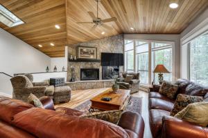 a living room with leather furniture and a fireplace at Newberry Lane 10 | Discover Sunriver in Sunriver