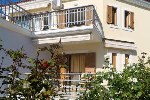 an external view of a house with a balcony at Eleni Suites Methoni in Methoni