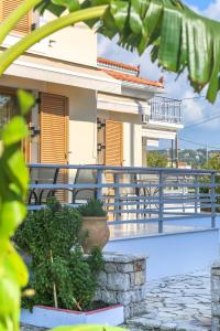 a villa with a swimming pool and a house at Eleni Suites Methoni in Methoni