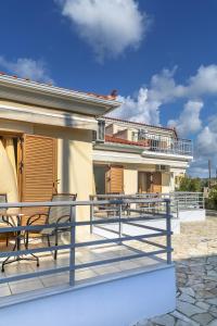 a balcony with two benches and a building at Eleni Suites Methoni in Methoni