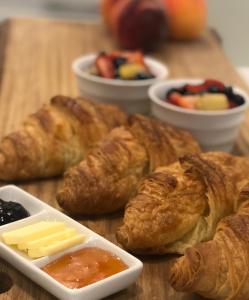 a table with croissants and other pastries and fruit at Harrogate House Inn in Niagara-on-the-Lake