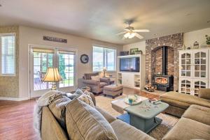 a living room with a couch and a fireplace at McMinnville Wine Country Home with Hot Tub and Deck in McMinnville