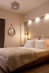 a bedroom with a large bed with white pillows at Langi Apartments in Missolonghi