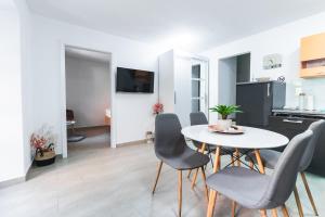 a kitchen and dining room with a table and chairs at Apartments Lara Renovated 2023 in Piran