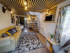 a living room with a couch and a table at A Ház in Kismaros