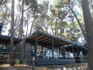 a modern house in the woods with trees at Mobile Home Erna, Rovinj in Rovinj