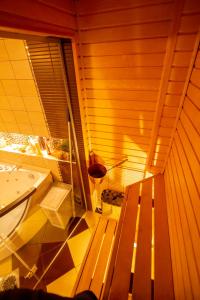 a sauna with a wooden bench and a sink at Niine apartment 11 in Haapsalu