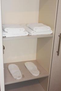 two shelves in a bathroom with white towels on them at Guest House Old Tiflis 5 in Tbilisi City