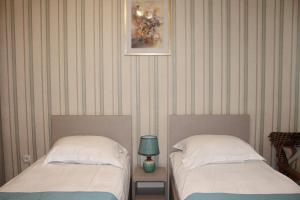 two beds sitting next to each other in a room at Guest House Old Tiflis 5 in Tbilisi City