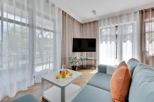 Televízia a/alebo spoločenská miestnosť v ubytovaní Ocean Mint - Apartamenty przy plaży