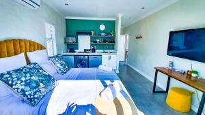 a bedroom with a large bed and a kitchen at Exquisite Pont de Val Riverside Escape Apartment in Parys