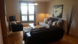 a living room with a couch and a table at Sky Night Serviced Apartments in Cardiff