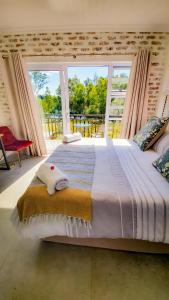 a large bed in a room with a large window at Exquisite Pont de Val Riverside Escape Apartment in Parys