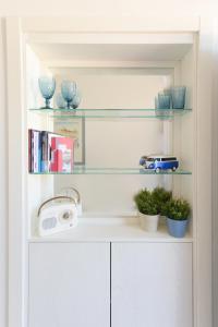 a book shelf with a radio and some plants at B&B Mediterraneo in Procida +223 photos