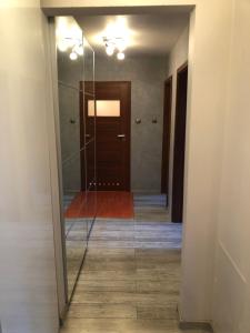 a glass door leading to a hallway with a door at Apartament Zielone Bielany in Warsaw