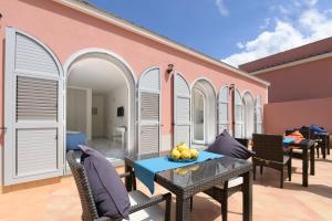 a patio with a table and chairs and a building at B&B Mediterraneo in Procida