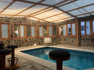 a swimming pool in a house with a ceiling at Casa rural Cristina- Piscina climatizada in Málaga