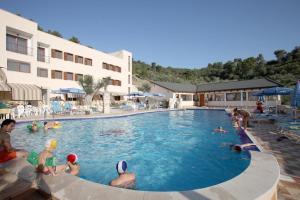a group of people in a pool at a hotel at Agriturismo AgriCostella Vieste, Piscina e Parcheggio in Vieste