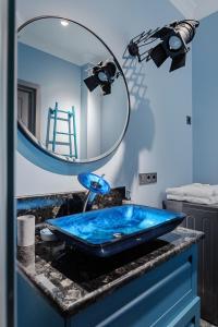 a bathroom with a blue sink and a mirror at VIP apartments with sea view in Odessa in Odesa