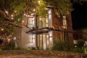 a brick house with lights on it at night at Areval Hotel Boutique de Lago & Eventos in San Cristóbal Zapotitlán