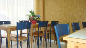 a dining room with a table and blue chairs at Hotel des Vosges in Paris