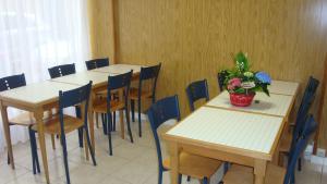 a room with tables and chairs and a potted plant at Hotel des Vosges in Paris