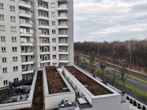 an apartment building with a row of garden beds at ParkCity Katowice in Katowice