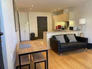 a living room with a couch and a table at Liverpool City Princes Dock Apartment in Liverpool