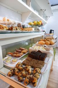 a display case with many different types of food at Pousada Tia Eni in Gramado