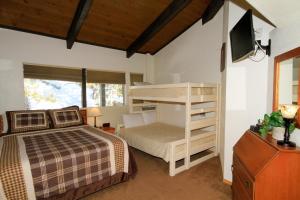 a bedroom with a bunk bed and a tv at Sierra Park Villas #29 in Mammoth Lakes
