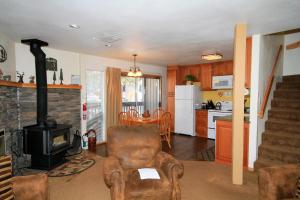 a living room with a chair and a stove at Sierra Park Villas #29 in Mammoth Lakes