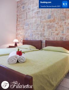 a bedroom with two beds with towels on them at Villa Filaretos in Vavkerí