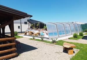 a glass house with a reflection of the ocean at Villa Kalypso in Bihać