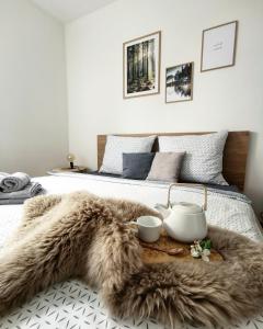 a bedroom with a bed with a brown fur rug at Apartmány Ve stodole in Roudnice nad Labem