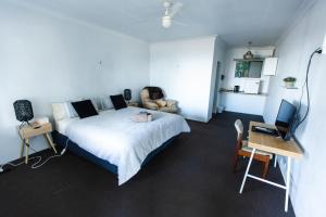 a bedroom with a bed and a desk with a computer at Archibald Hotel in Kurrajong