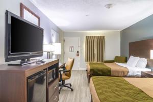 a hotel room with two beds and a flat screen tv at SureStay Hotel by Best Western Brunswick in Brunswick