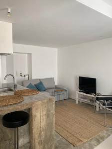 a living room with a couch and a table at Fran Pacheco 39 (downtown apartment) in Setúbal