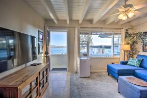 a living room with a blue couch and a tv at Mission Point, San Diego Hub - 1 Block to Beach! in San Diego