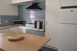 a kitchen with a table with a hat on it at Cute cottage walking distance to CBD in Wagga Wagga