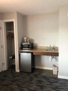 a kitchen with a counter with a microwave and a sink at Park Lane Motel in Lake George
