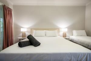 Postel nebo postele na pokoji v ubytování Woolgoolga Coast Motel