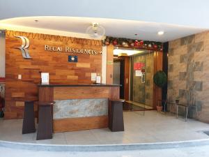 a hotel lobby with a reception desk in a building at Regal Residences in Manila