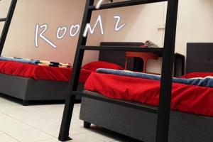 a room with two bunk beds with red sheets at STAY N REST SWEET HOME Duyung 207 in Seremban