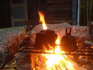 a fire pit with two bells on top of it at Laawu Kultaa in Kotka