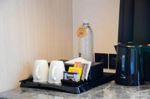 a tray with a bottle of water on a table at The Manohara Hotel Yogyakarta in Yogyakarta