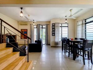 a dining room and living room with a table and chairs at Alyssa Homestay Putrajaya in Putrajaya