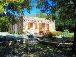 un cottage en pierre au milieu d'un jardin dans l'établissement Les jardins de Foata, à Barbaggio