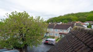 a van parked in a parking lot next to houses at S6 Ensuite Loft Studio Space (Sandycroft Guest House) in London