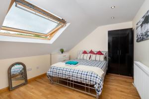 a bedroom with a bed and a skylight at S6 Ensuite Loft Studio Space (Sandycroft Guest House) in London